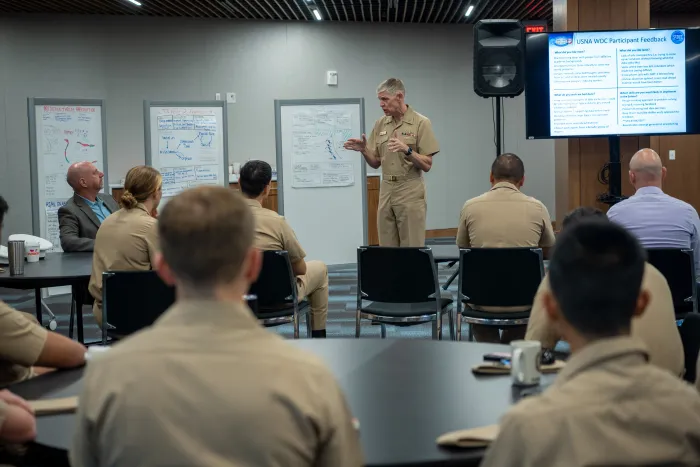 Chief of Naval Research Rear Adm. Lorin Selby speaks to recent graduates of the U.S. Naval Academy after they gave their counternarcotics presentations to leaders of the SCOUT initiative. During this “design thinking” event, the graduates shared their ideas for addressing a major challenge facing the Joint Interagency Task Force-South — limited resources to cover a huge area of operations to counter narcotics smuggling into the U.S. (U.S. Navy photo by Michael Walls)