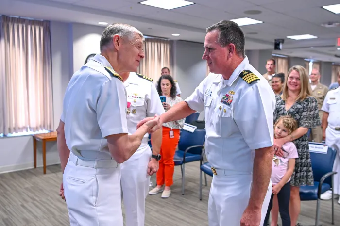 Chief of Naval Research Rear Adm. Lorin Selby (left) and new NavalX Director Capt. Casey Plew exchange handshakes during the NavalX change-of-office ceremony on Sept. 13, 2022. The ceremony welcomed Plew, who took the reins from Capt. Benjamin Van Buskirk. NavalX serves the U.S. Navy and Marine Corps as an innovation and agility cell, supporting and connecting initiatives across the DoD. (U.S. Navy photo by Michael Walls)