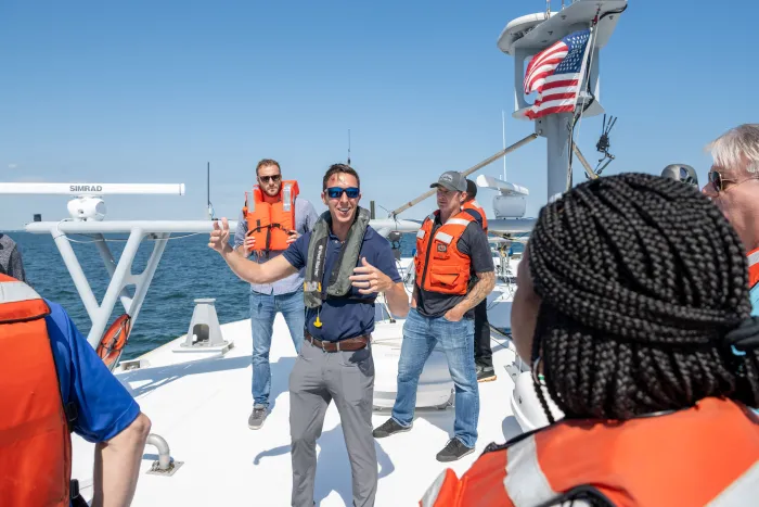 John Phillips (center), an ONR SCOUT lead who also works at NSWC Carderock, talks to participants during a recent ONR SCOUT-sponsored experimentation event off the coast of Virginia Beach, Virginia. The purpose of the event was to increase the range and detection of various unmanned surface vessels. (Photo: ONR SCOUT team)