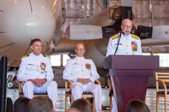 Chief of Naval Research Rear Adm. Kurt Rothenhaus speaks during a July 13 change-of-command ceremony at Naval Air Station Patuxent River, Maryland, for the Office of Naval Research Global. Capt. Andy “Big Tuna” Berner (left) took command for Capt. Matthew Farr (center).