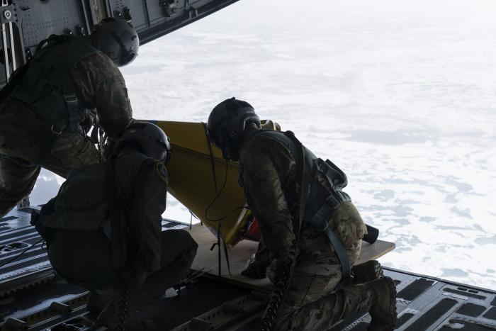 From left to right, Alaska Air National Guard Senior Master Sgt. Brian Johnson, Tech. Sgt. Chris Eggleston and Senior Master Sgt. Cecil Dickerson, loadmasters assigned to the 144th Airlift Squadron at Joint Base Elmendorf-Richardson, prepare to deploy an Air-Deployable Expendable Ice Buoy (AXIB) buoy during an airdrop mission over the Arctic Ocean, July 12, 2023. The Office of Naval Research partnered with the 144th AS to deploy five different types of data-gathering buoys across