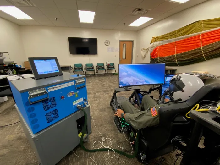 A U.S. Navy aviator receives training on the TS-872 Breathing Dynamics Trainer at the Naval Survival Training Institute in Orlando, Florida. The TechSolutions-sponsored TS-872 allows aviators to experience the effects of breathing issues in a safe training environment, such as hyperoxia (too much oxygen) and excessive inhalation/exhalation pressures. 