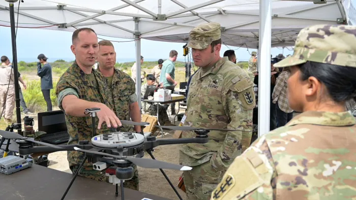Attendees at the Technical Concept Experiment (TCE) 23.2, held at Camp Pendleton, California, discuss a system tested during the event. TCE 23.2 showcased multiple systems designed to enhance the Marine Corps’ capability in carrying out amphibious operations — including explosive hazard defeat/mine countermeasures as well as intelligence, surveillance and reconnaissance. (U.S. Navy photo by Michael Walls)