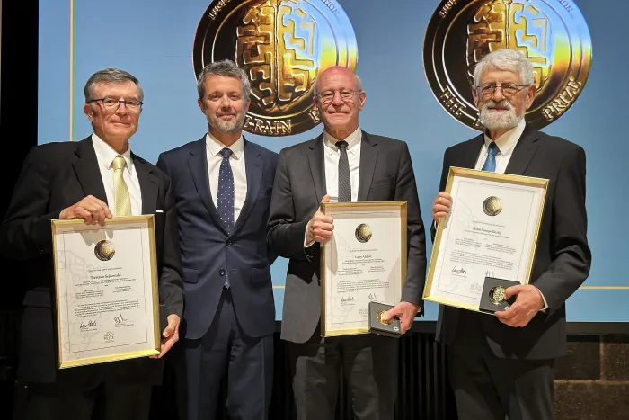 Two ONR-sponsored performers, Dr. Terrence Sejnowski (left) and Dr. Haim Sompolinsky (right), received the 2024 Brain Prize during a ceremony in Copenhagen, Denmark. Standing with them are His Royal Highness King Frederik X of Denmark (center left) and another Brain Prize winner, Dr. Larry Abbott (center right). (Photo courtesy of Dr. Terrence Sejnowski)