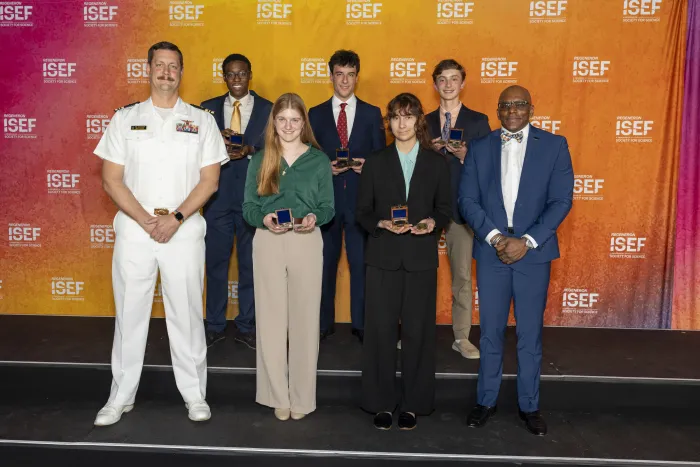 Lt. Cmdr. (retired) Raymond Guethler, an instructor of Practical Applications at the U.S. Naval Academy (left), and Anthony C. Smith Sr., director of the DoN HBCU/MI Program (right), stand with the recipients of this year’s Chief of Naval Research Scholarship Awards. (Photo courtesy of DoN HBCU/MI Program)