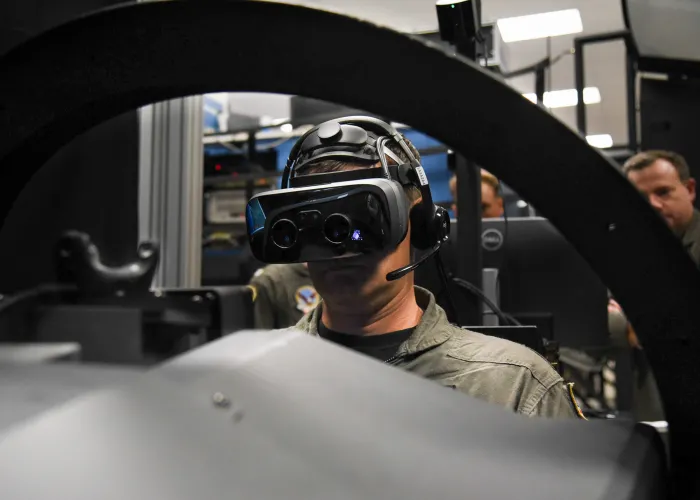 Capt. Juston Kuch, Training Air Wing One Commodore, operates a simulated T-45 Goshawk in the Operational Flight Trainer onboard NAS Meridian. The simulators incorporate augmented-reality technology to enhance student pilot training. (U.S. Navy photo by Petty Officer 2nd Class Molly Tice)
