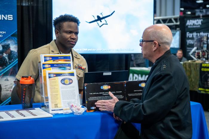 Chief of Naval Research Rear Adm. Kurt Rothenhaus (right) visits exhibits at Modern Day Marine in Washington D.C., April 29, 2025. Modern Day Marine is the largest military equipment, systems, services and technology exposition exclusively targeted to the Marine Corps. The Office of Naval Research hosted several exhibits at the expo, showcasing how the command helps the Marine Corps achieve mission success in an increasingly complex military landscape. (U.S. Navy photo by Michael Walls)