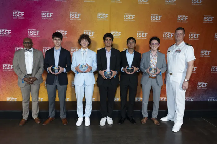 Anthony C. Smith Sr., director of the DoN HBCU/MI Program (left) and Lt. Cmdr. (retired) Raymond Guethler, an instructor of Practical Applications at the U.S. Naval Academy (right), stand with the recipients of this year’s Chief of Naval Research Scholarship Awards. (Photo courtesy of DoN HBCU/MI Program)