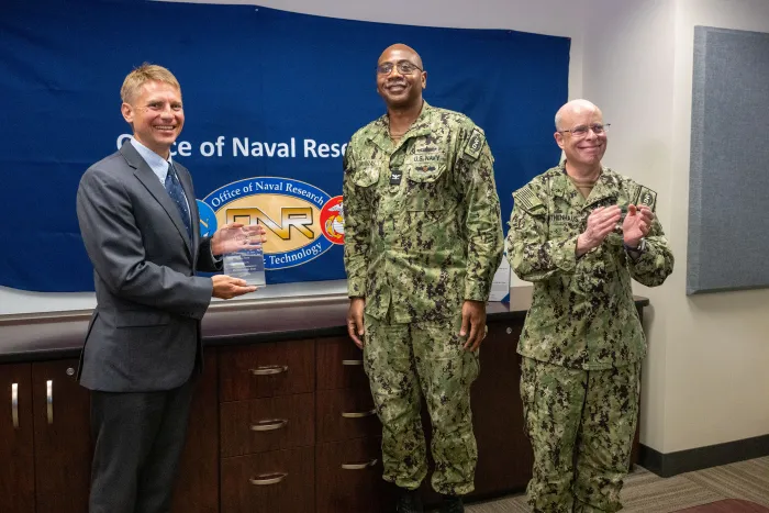 ONR's Peter Squire (left), Ph.D, program officer in the Warfighter Performance Department received two 2025 Dr. Delores M. Etter Top Scientist and Engineer awards for his contributions to warfighter lethality and readiness during a virtual awards ceremony on June 25th. The awards were presented by ONR's Chief of Naval Research, Rear Adm. Kurt Rothenhaus (right) and Assistant Chief of Naval Research Capt. David Murray (center). (U.S. Navy Photo by Micheal Walls.)