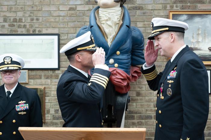 Capt. Eric “Nutt” Hutter, incoming commanding officer, salutes Capt. Andy “Big Tuna” Berner, outgoing commanding officer, during the Office of Naval Research  Global’s Change of Command ceremony at the HMS President, a shore establishment of the Royal Naval Reserve in London, Sept. 4. (U.S. Air Force photo by Airman 1st Class Adam Enbal, 501st Combat Support Wing)