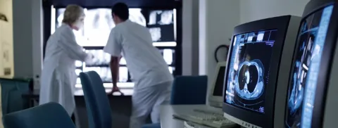 Two lab technicians review x-rays.