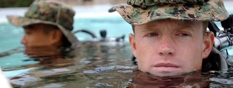 A U.S. Marine, enrolled in the Marine Combat Diver course, waits to participate in the next evolution in the pool at the Navy Diving & Salvage Training Center.