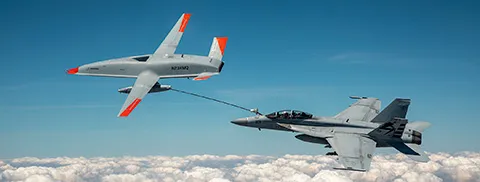 An unmanned Boeing MQ-25 T1 Stingray test aircraft, left, refuels a manned F/A-18 Super Hornet. (U.S. Navy photo courtesy of Boeing)