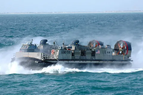 Landing Craft, Air Cushion (LCAC) 50 flies alongside amphibious platform dock ship USS San Antonio (LPD 17)