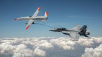 An unmanned Boeing MQ-25 T1 Stingray test aircraft, left, refuels a manned F/A-18 Super Hornet. (U.S. Navy photo courtesy of Boeing)