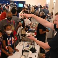 Attendees watch a science demonstration during the Navy League STEM Expo, held Sunday, Aug. 1, at the Gaylord National Resort and Convention Center in National Harbor, Maryland. The free event gave local students the opportunity to engage and be inspired by all things STEM—or science, technology, engineering and math. It also enabled them to learn about a deadline extension and potential prizes for the Naval Horizons student essay contest—organized by the Department of the Navy’s Naval STEM Coordination Off