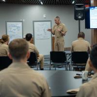Chief of Naval Research Rear Adm. Lorin Selby speaks to recent graduates of the U.S. Naval Academy after they gave their counternarcotics presentations to leaders of the SCOUT initiative. During this “design thinking” event, the graduates shared their ideas for addressing a major challenge facing the Joint Interagency Task Force-South — limited resources to cover a huge area of operations to counter narcotics smuggling into the U.S. (U.S. Navy photo by Michael Walls)