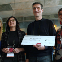 The team from Bio-Synthetic Lifeforms holds a mock check for $50,000 as one of the three winning grantees from the Serendipity Collective. (Photo courtesy of IdeatePlus)