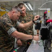 U.S. Marines inspect equipment in the ONR-sponsored Expeditionary Fabrication Laboratory (XFAB) during Autonomous Warrior 2023 in Australia. (U.S. Navy photo by Michael Walls)
