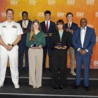 Lt. Cmdr. (retired) Raymond Guethler, an instructor of Practical Applications at the U.S. Naval Academy (left), and Anthony C. Smith Sr., director of the DoN HBCU/MI Program (right), stand with the recipients of this year’s Chief of Naval Research Scholarship Awards. (Photo courtesy of DoN HBCU/MI Program)