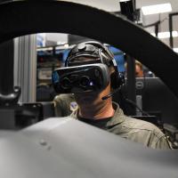 Capt. Juston Kuch, Training Air Wing One Commodore, operates a simulated T-45 Goshawk in the Operational Flight Trainer onboard NAS Meridian. The simulators incorporate augmented-reality technology to enhance student pilot training. (U.S. Navy photo by Petty Officer 2nd Class Molly Tice)