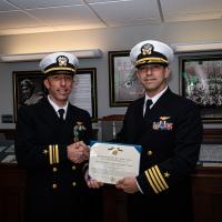 ONR Global Capt. Matthew Romero, TechSolutions outreach coordinator (right), presents Lt. Cmdr. Geoffrey Dick with the Navy and Marine Corps Achievement Medal for his leadership in championing, prototyping and transitioning to operations the TechSolutions TS-944 T-45 Mixed Reality (MR) Trainer at Naval Air Station Corpus Christi, Texas. (U.S. Navy photo by Morgan Galvin)