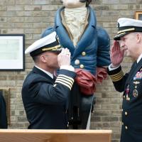 Capt. Eric “Nutt” Hutter, incoming commanding officer, salutes Capt. Andy “Big Tuna” Berner, outgoing commanding officer, during the Office of Naval Research  Global’s Change of Command ceremony at the HMS President, a shore establishment of the Royal Naval Reserve in London, Sept. 4. (U.S. Air Force photo by Airman 1st Class Adam Enbal, 501st Combat Support Wing)