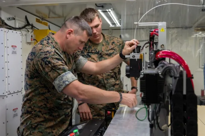 U.S. Marines inspect equipment in the ONR-sponsored Expeditionary Fabrication Laboratory (XFAB) during Autonomous Warrior 2023 in Australia. (U.S. Navy photo by Michael Walls)